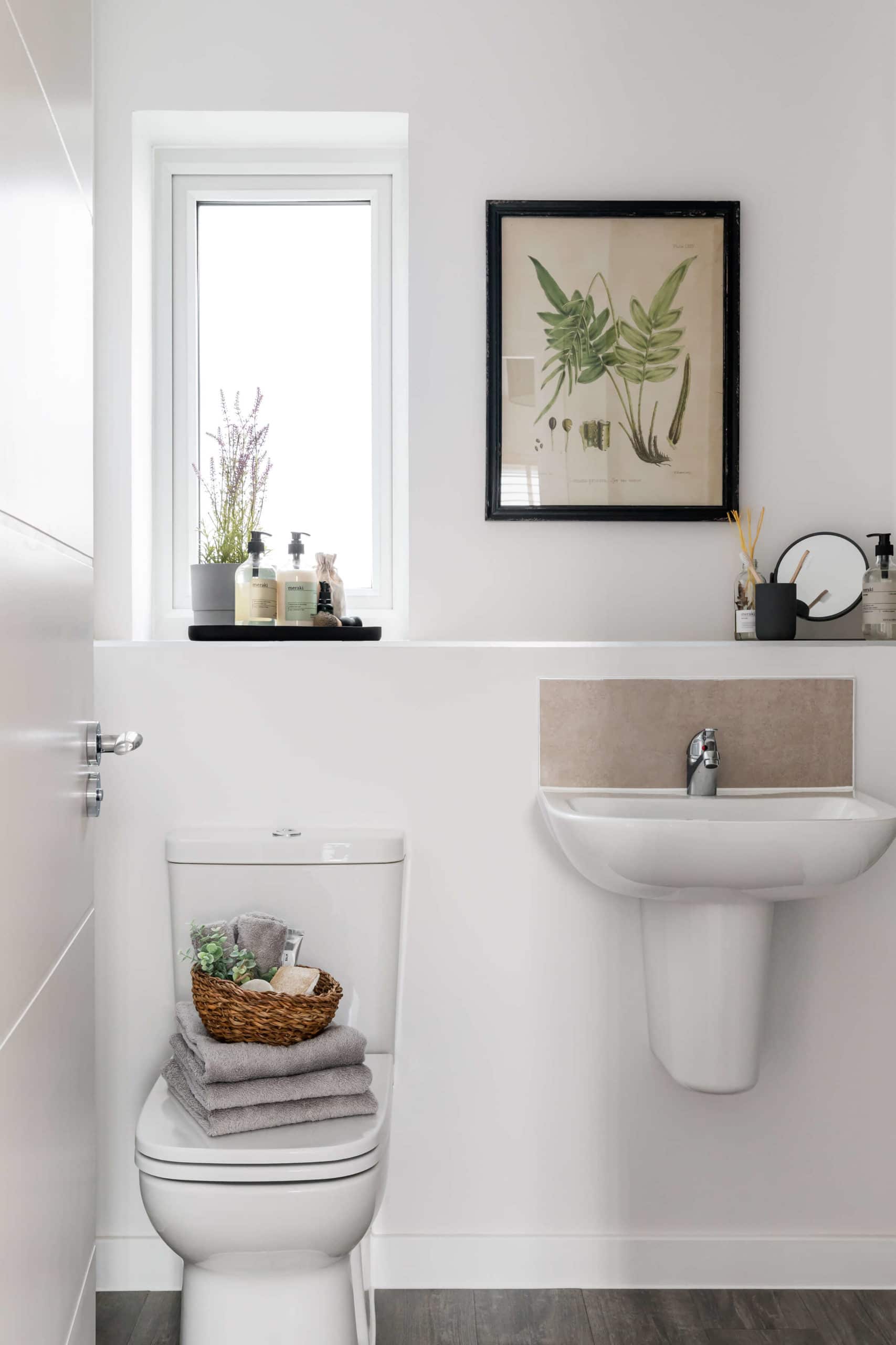 Bathroom with plants and nature-inspired artwork