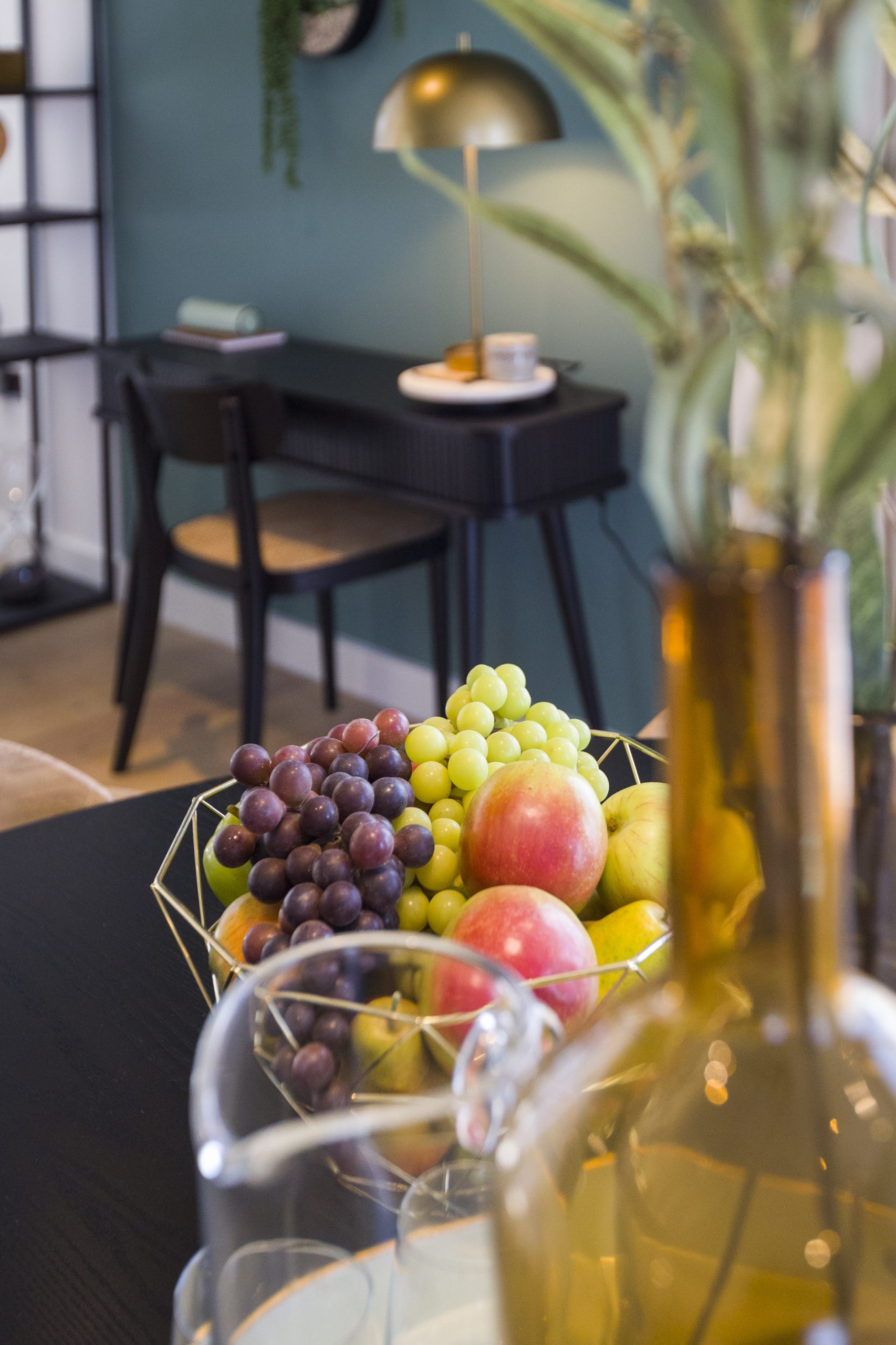 Close-up of fruit bowl and plant potter on dining table