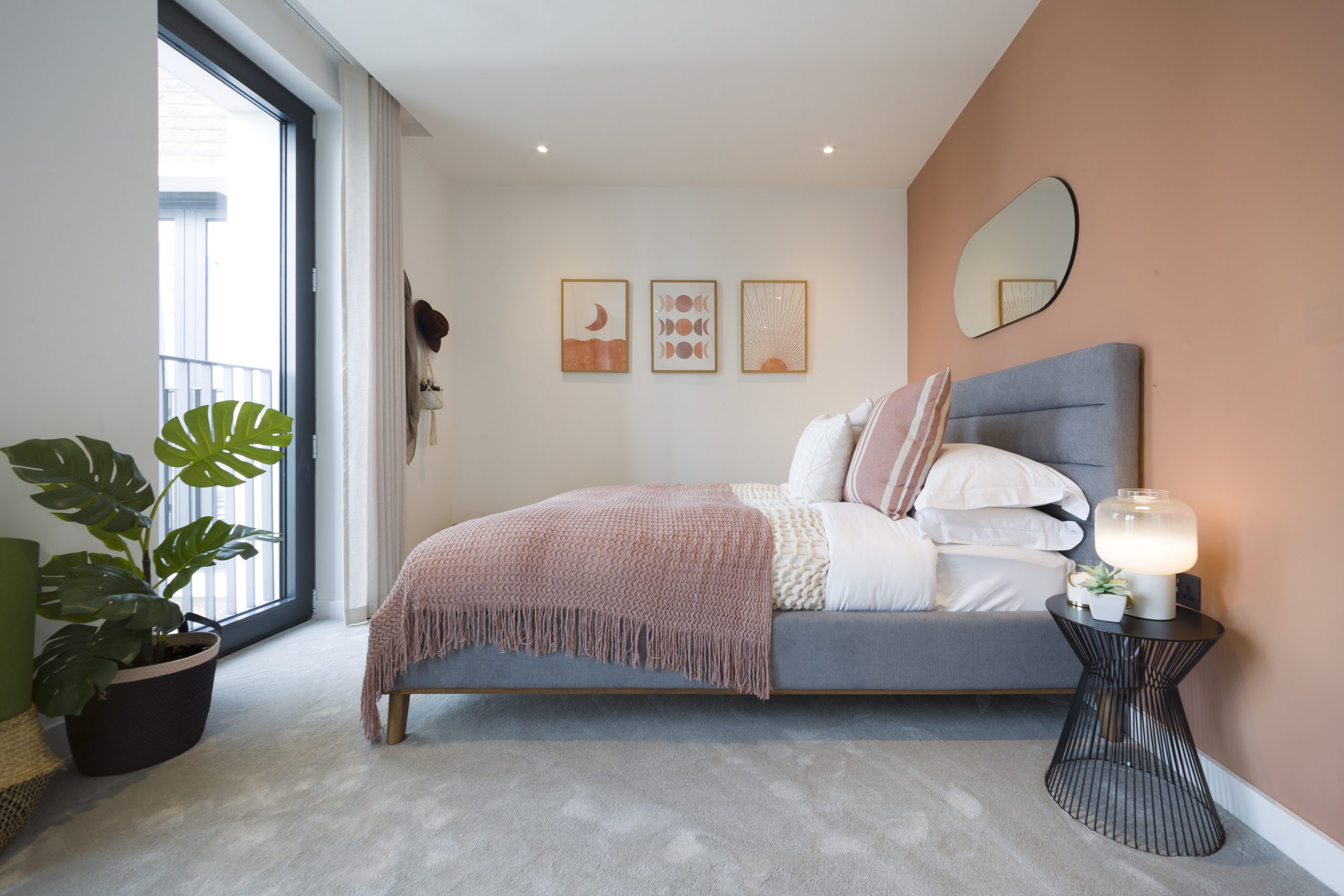 Pastel pink double bedroom facing a window to Central London