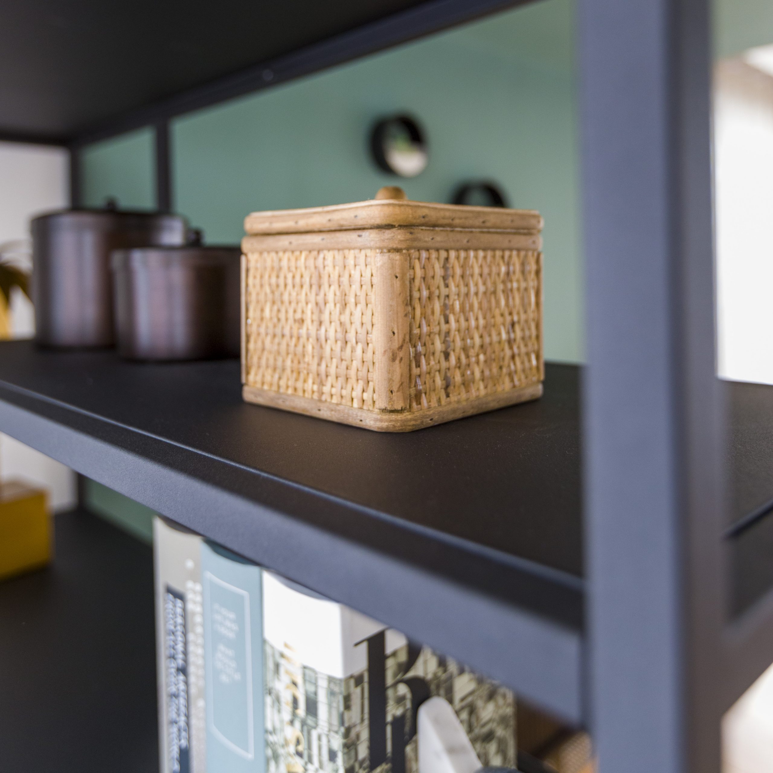 Close-up of small woven storage box on shelving unit