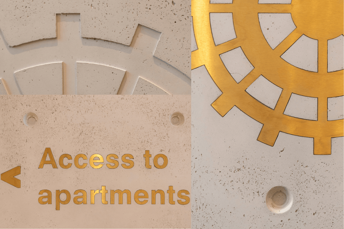 Brass embossed cogs and signage in concrete walls