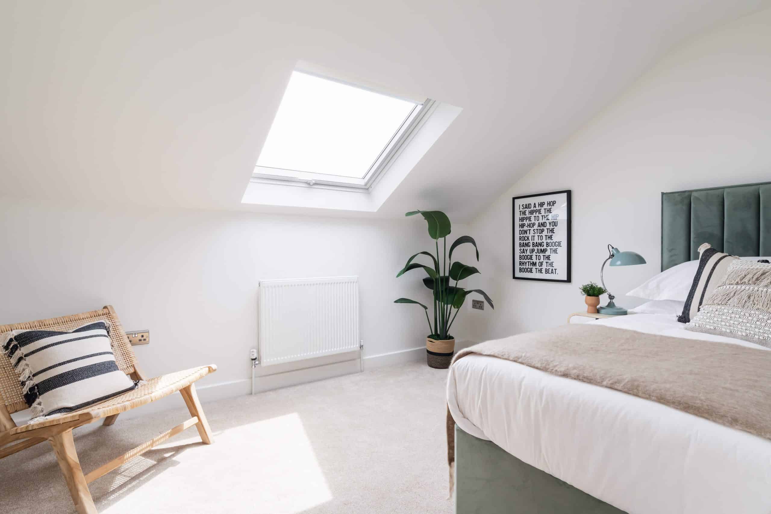 Bedroom 3: single bed of muted green accentuated with corner house plant and bedside lamp of same colour. Striped cushion and textured seating brings coastal feeling to the Dorset Airbnb