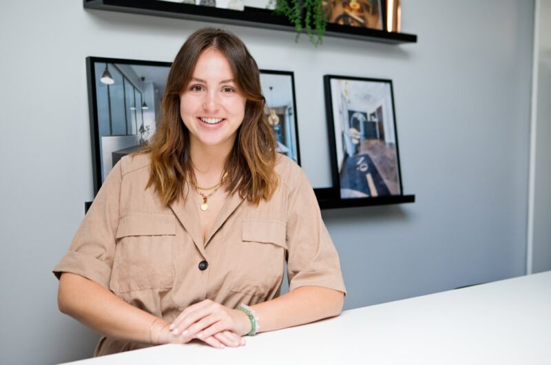 Jigsaw's interior designer Emily sitting in the Poole studio meeting table
