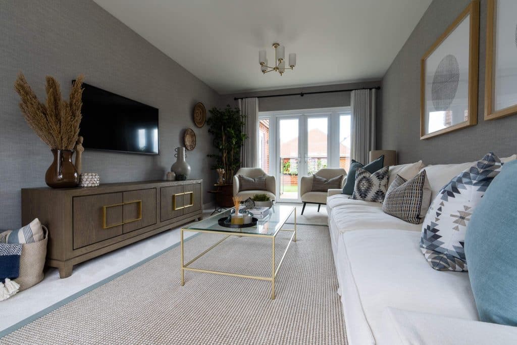 A picture of a neutral coloured living room with accents of blue.